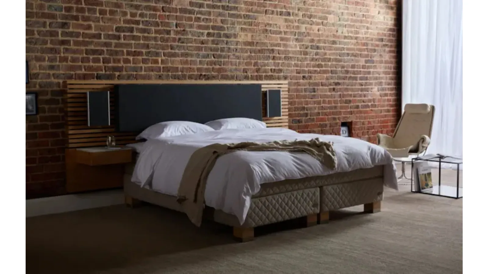 Bed with upholstered fabric and wood headboard by Duxiana