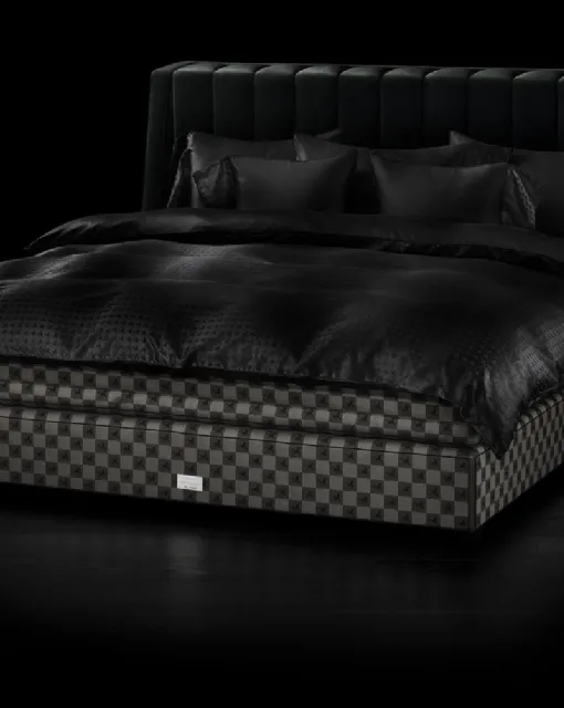 Fabric bed with Drēmər Black Shadow headboard by Hastens