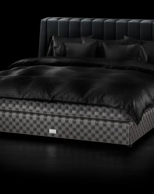 Fabric bed with Drēmər Phantom Charcoal headboard by Hastens