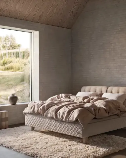 Bed with quilted fabric headboard by Duxiana