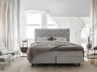 Bed with a Royal headboard in quilted and padded fabric by Duxiana